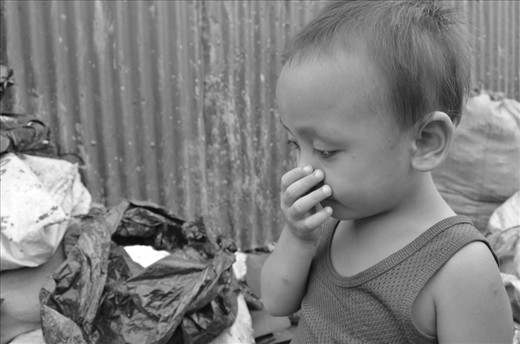 SENSE OF SMELL. People living in Payatas—even those at a very young age—are exposed 
to the nasty smell of their surrounding. They have to endure and get used to the 
stench, for collecting garbage is their primary livelihood. An innocent boy 
covers his nose as he stares at the amount of waste outside their home.
