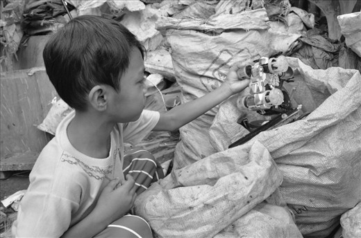 SENSE OF TOUCH. A young boy finds a toy car in a sack of segregrated trash. Instead 
of purely enjoying their childhood, the kids are already taught how to find 
reusable items from mounds of filthy garbage. They have to learn to rummage using 
their hands in order to get more money for the family.