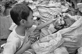 SENSE OF TOUCH. A young boy finds a toy car in a sack of segregrated trash. Instead 
of purely enjoying their childhood, the kids are already taught how to find 
reusable items from mounds of filthy garbage. They have to learn to rummage using 
their hands in order to get more money for the family.: by kurtzky, Views[1719]
