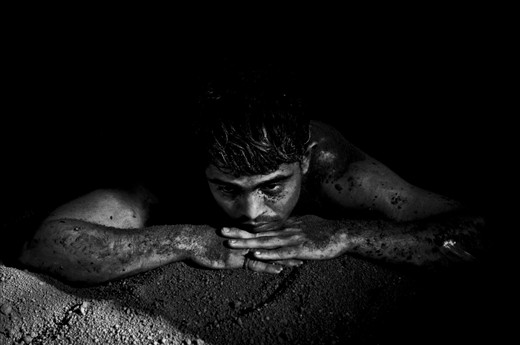 I spend a week documenting the lives of these kushti wrestlers in Mumbai in 2011. I went back last year for another week to work again on the story. 

The men live their lives according to ancient old rules and diets. The conditions they live in are very simple. 

The light conditions were quite though as light came only in via two small windows. All images though were made hand held and without the use of flash!

A rest or meditative moment after a grueling work out.