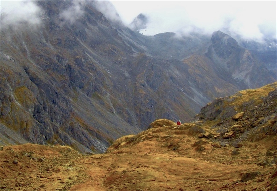 Mint Hut: Surrounded by snowy peaks and jagged slopes the Mint Hut sits on a mossy field in the distance. Built in 1971 and maintained by the Mountaineering Club of Alaska the hut allows members a base camp for a multitude of outdoor activities or visitors can simply relax and enjoy the solitude of the surroundings.
