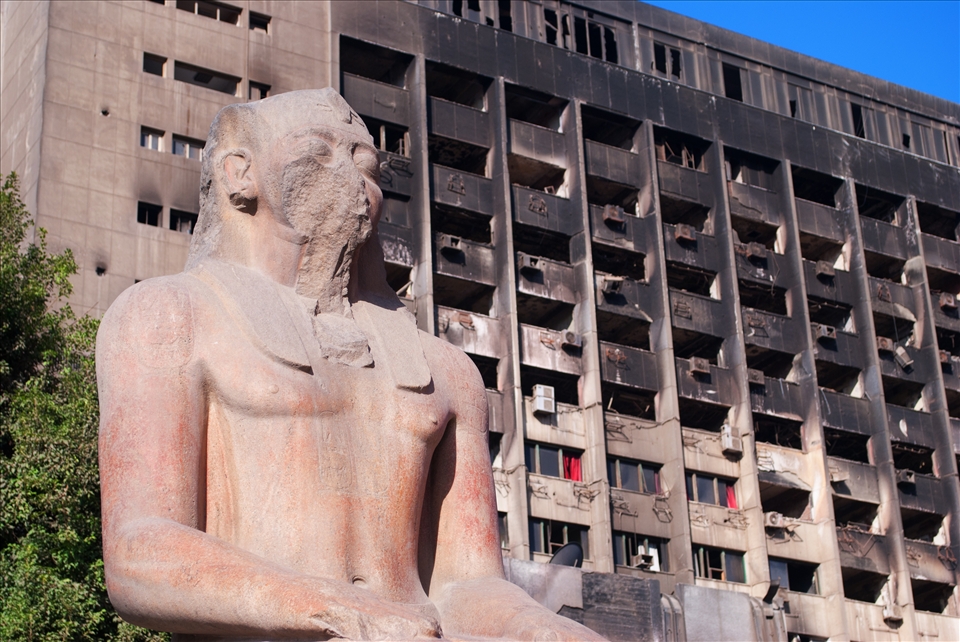 Ancient Egypt shadowed by the burnt out shell of the 2011 Egyptian Revolution.