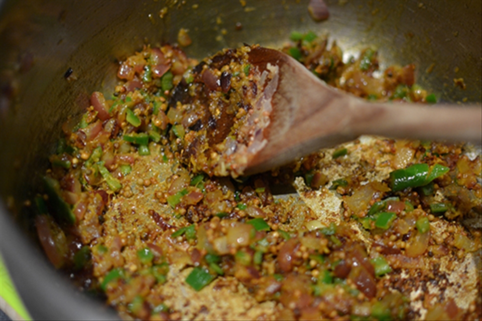 Fragrant chillis, garlic, onion and mustard seeds cooking