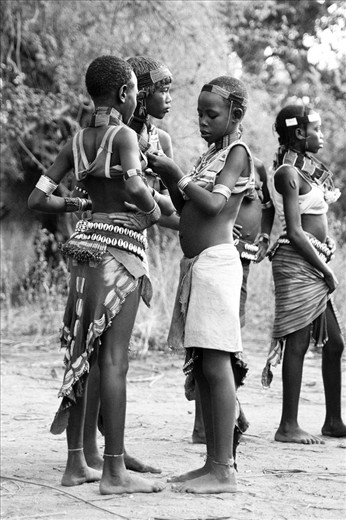 Although too young to take part in the festivities and whipping, young girls tie up their tops mimicking their elder sisters and mothers.