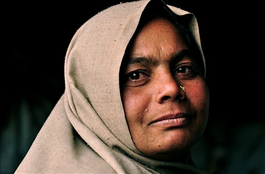 A woman sits in her plastic house in the slums of Kathmandu, Nepal.