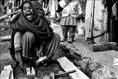 A young girl breaks firewood in a small slum in the Kathmandu Region, Nepal.: by lachlanmcgarvie, Views[284]