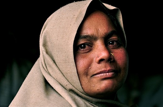 A woman sits in here plastic house in the slums of Kathmandu, Nepal. She houses and cares for her entire family under plastic tarpaulins and cooks with old and rusted utensils. However during my visit through Nepal I did not meet people who were genuinely happier than these families within the slums. 