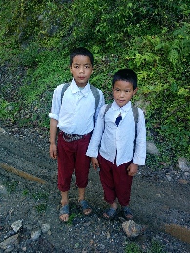 Nepalese boys on their way down the mountainside to school. 