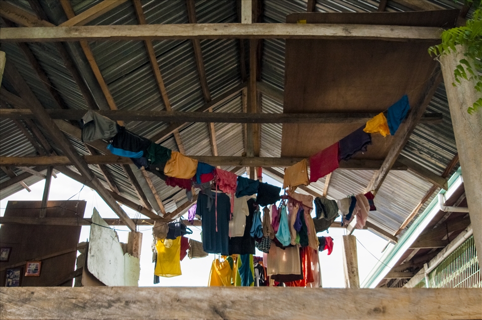 A typical open air home on Pandanon. The days washings air dries  at sunset.