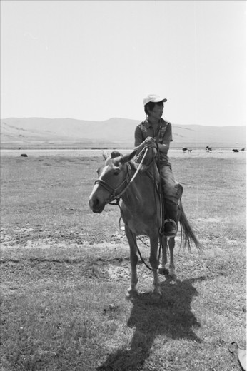 My horse trip guide, Onna, taking a rest on the horseback, under the really hot weather at noon in July.