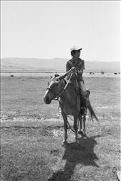 My horse trip guide, Onna, taking a rest on the horseback, under the really hot weather at noon in July.: by lambpacker, Views[290]