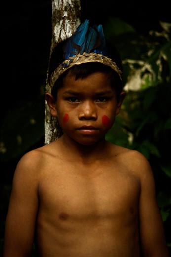 The middle boy wears decorative Macaw feathers, a gift from his father.