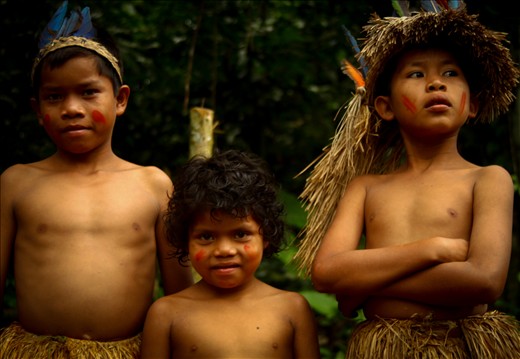 In a remote pocket of the Western Amazonian basin in Peru lies the Yagua tribe. In the Yagua community, boys are introduced into manhood from age fourteen where the hunting traditions are passed down from an uncle. Here the youngest boys in the tribe remain in the village while the Wanù (men) hunt for food. During the hunt, the eldest boy of the tribe is given the chief’s headdress typically made of aguaje grass and macaw feathers. Here the Tribal brothers standing at the outskirts of the village.