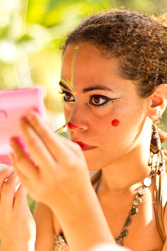 The background. A girl making up for a cultural presentation at a park in Niterói, Rio de Janeiro.