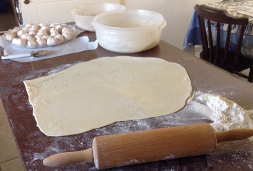 The anari cheese on the left and the dough has been rolled out