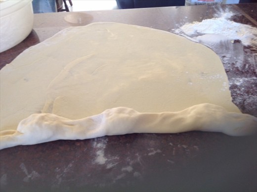 The cheese portions are covered by the dough as it is folded over