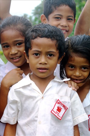 Children walking home cluster around.