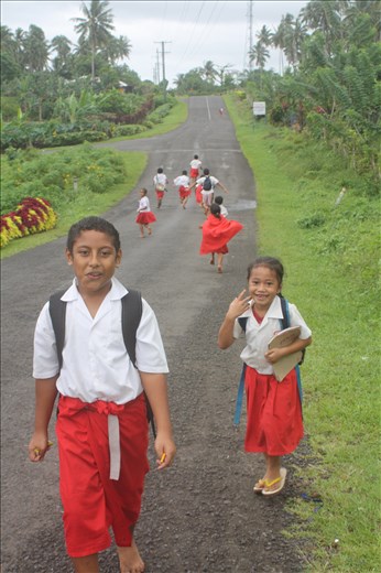 A rain shower scatters school children heading home.