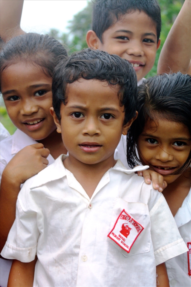 Children walking home cluster around.