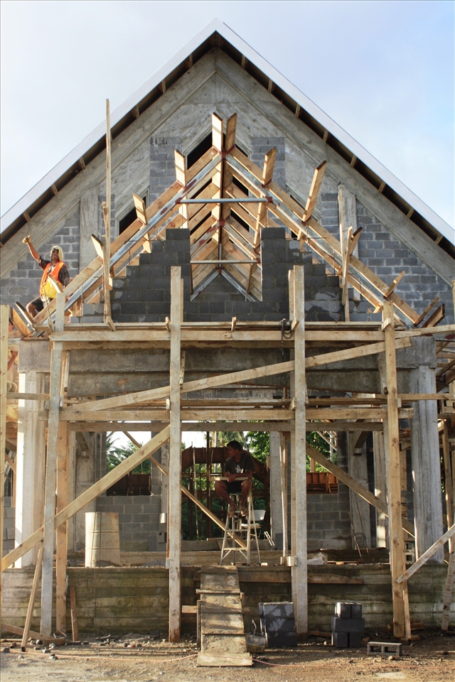 Workers smile and continue work in a break in the weather