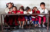 A group of first-graders wait for their teacher to arrive at Kent College Nepal in Lahachowk. Many children walk for an hour to get to this remote school and then sit on their classroom benches ready for the day to begin.: by lauracook, Views[373]
