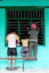 Children unable to afford school uniforms look longingly in the window. Primary education is free in Nepal but books and uniforms cost money and many children are expected to help at home during the day. Teachers at Kent College are happy to allow the onlookers the chance to learn through the open window.: by lauracook, Views[445]