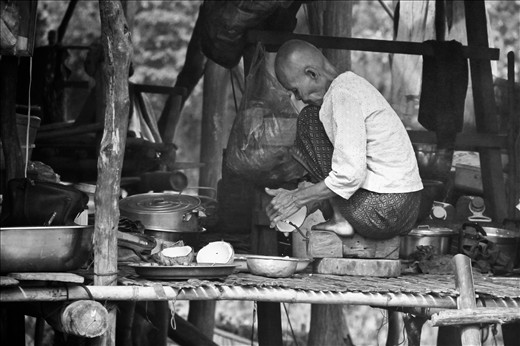 Most women spend the day inside the home cooking and doing daily chores, such as this nun preparing some coconut milk for lunch. 