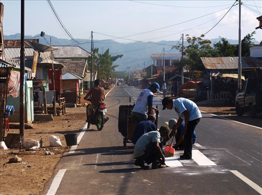 Painting the road signs in Indonesia.