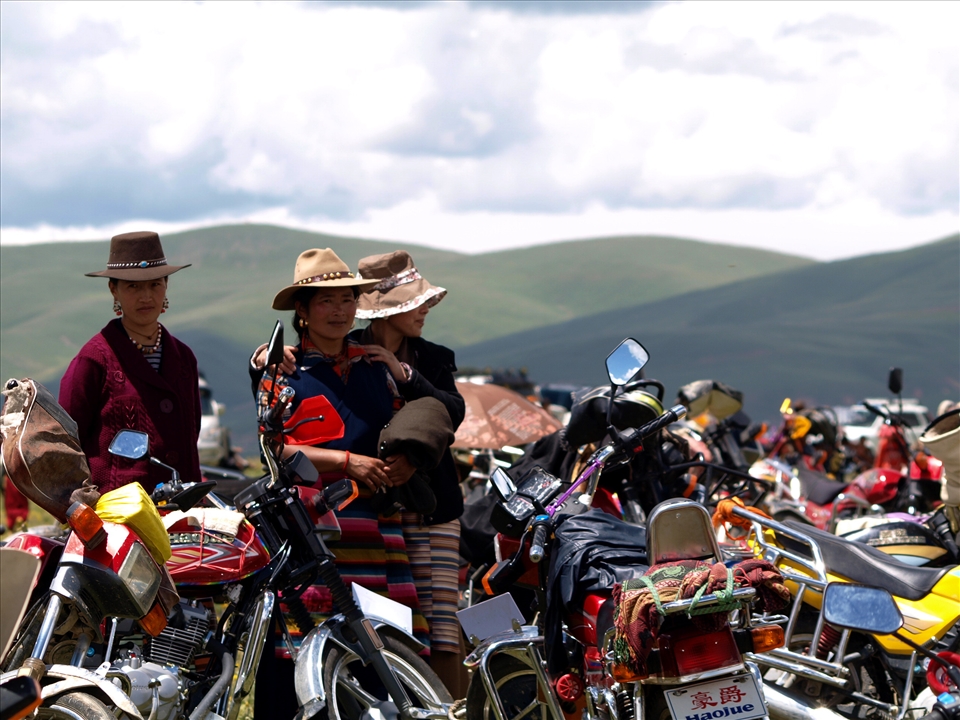 3..4...never too many people to travel to the racecourse on the one motorbike.