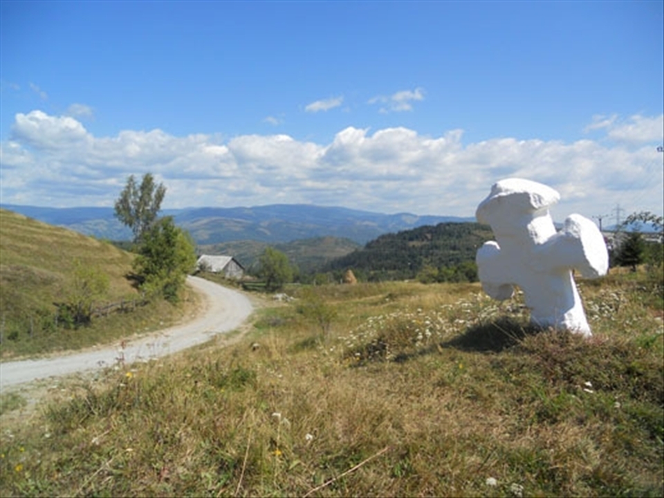 Travelling in the Romanian countryside, one would find many crosses and religious monuments at crossroads or side roads. They were made to help the traveler choose the right way, to inspire him to pray and ask the protection of the Holy Trinity. In Rosia Montana, there are made of rock and sometimes painted with limestone, prime materials which are plenty in the area.