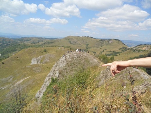 Rosia Montana with its existence of almost two millennia is a mining village in Transylvania, subject to high controversy due to a mining project owned by a gold-hunting Canadian company.  NGOs and private people unite their forces to preserve the ancient village and to make it a UNESCO World Heritage site. Once a year, they organize FanFest (Hay Festival) to make people aware of the beauty that this area holds and that tourism could be a worthy choice for the people in Rosia Montana. I managed to take a shot with the hand of our guide, also a volunteer, who was showing us the village from the top of a mountain. In the back, there is another group of visitors enjoying the beautiful vista that the rich Rosia Montana gives for free.