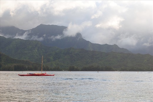 Storm Clouds desend from the mountains along the Napali Coast of Kuai' Hawai'i but that doesn't discourage one lone man in his out-rigger canoe, he sits at the mercy of the wind and water watching the ancient gods of volcanoes and jungles dance with the waves.