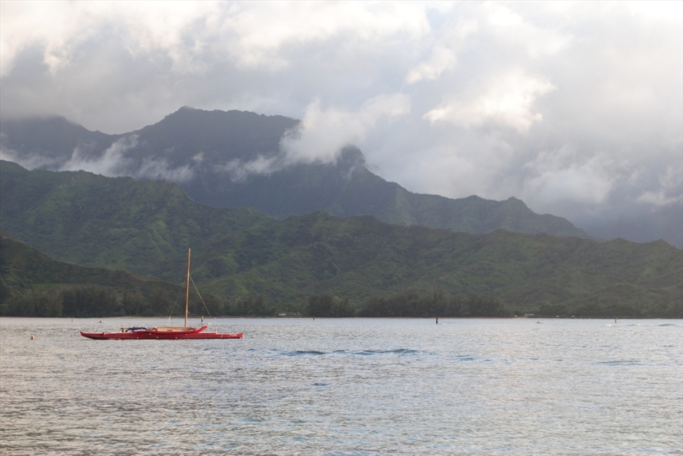 Storm Clouds desend from the mountains along the Napali Coast of Kuai' Hawai'i but that doesn't discourage one lone man in his out-rigger canoe, he sits at the mercy of the wind and water watching the ancient gods of volcanoes and jungles dance with the waves.