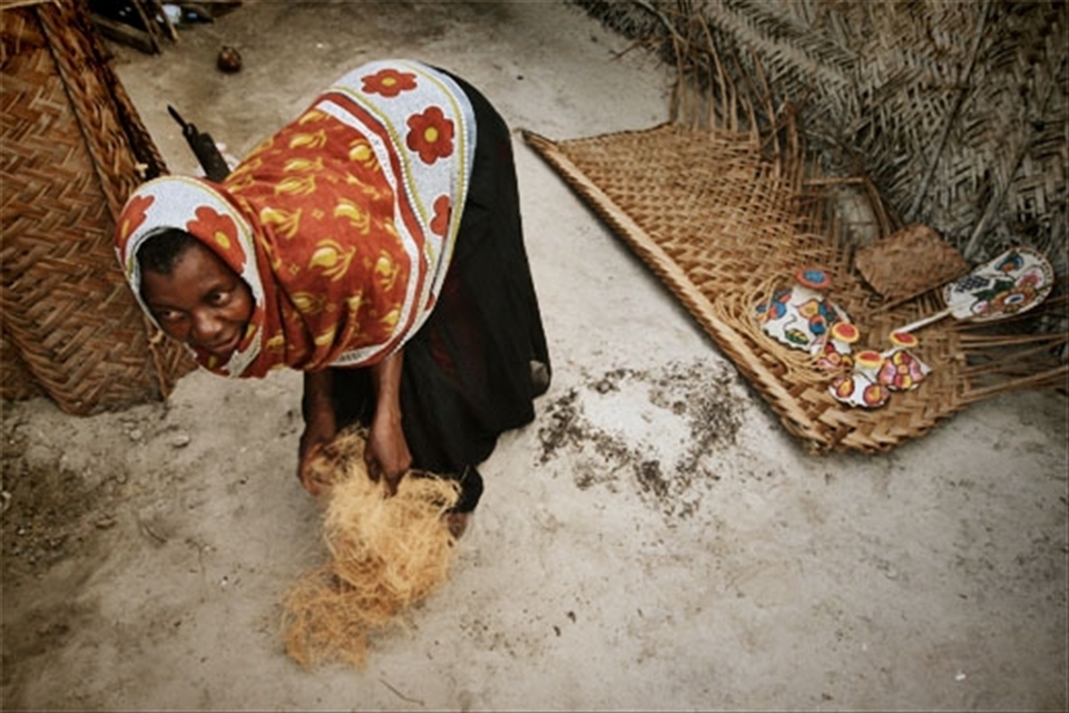 Woman making rope from coconut 