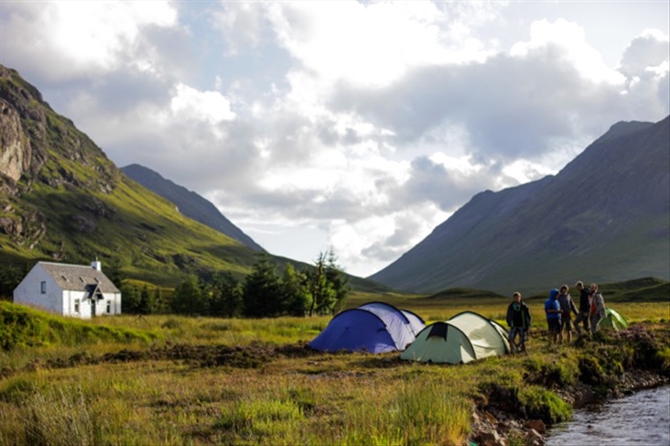 Camping on the mountainside next to a deserted farmhouse.