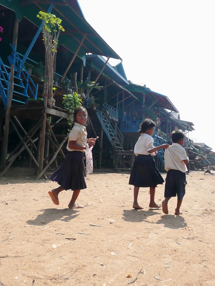 The dry season in Kampong Phluk exposes the 6 metre tall stilted structure of the village where children play on solid land.