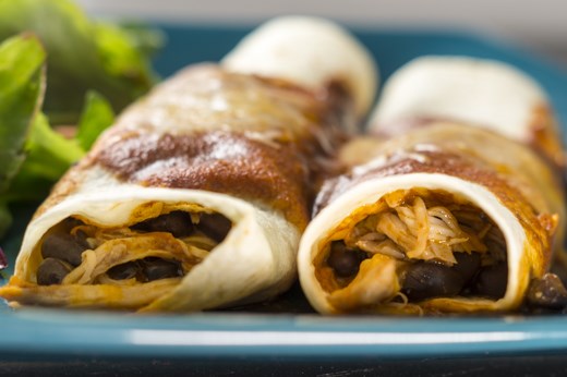 Tender shredded chicken embraced by soft flour tortillas and bathed in smoky rich sauce