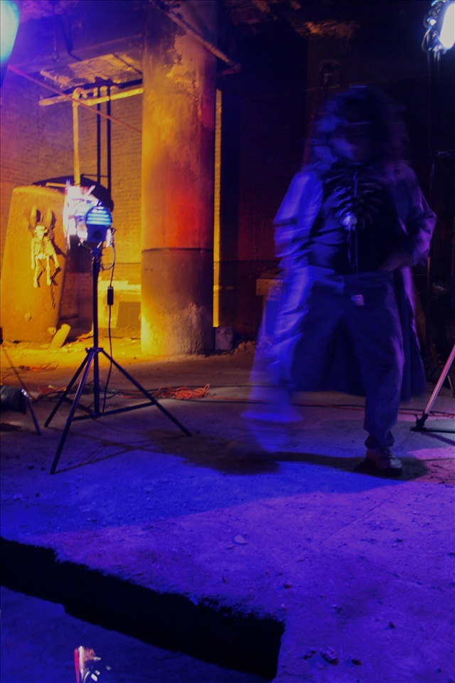 An actor conjures some motivation between sets.