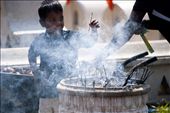 A young devotee burns incense at the Temple. The burning of incense is said to be a symbol of good morality and the cultivation of good moral conduct.: by leeherath, Views[362]