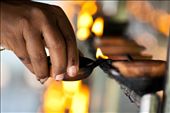 A devotee lights a lamp at the Temple. Light is said to be a symbol of wisdom. The lighting of lamps is said to generate wisdom and dispel the darkness of ignorance.: by leeherath, Views[1117]