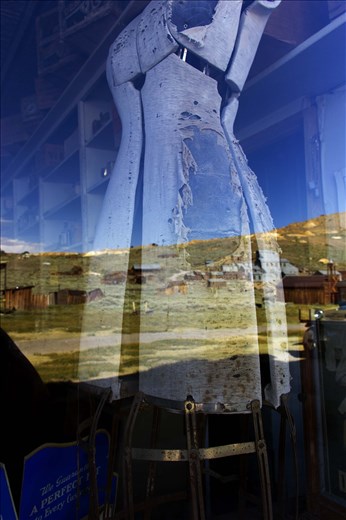 Dress shop, with the closed gold mine in the window reflection. 