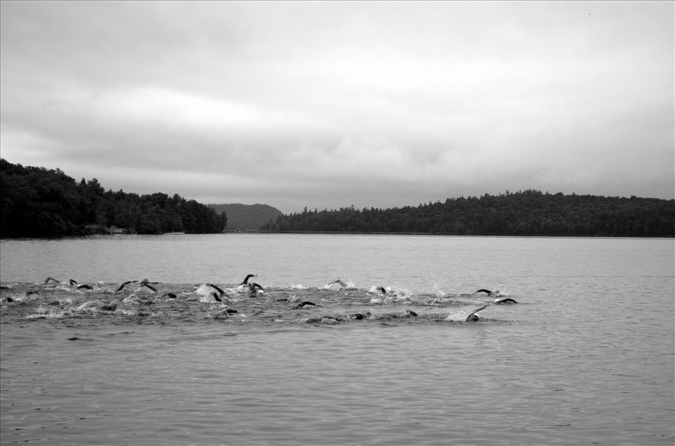 Tupper Lake, New York - Tinman Triathlon. Many People have never seen the athlete's side of a 6 hour physical competition. 'The Rush Hour' shows the group of 18-39 year old wave attempting this endeavour. 