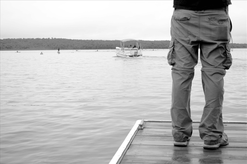 As the Tinman is only minutes underway, an anxious onlooker from the docks watches as a supervisor boat powers to rescue it's first swimmer. 