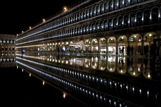 'Swan Song', shot in St Mark's Square, Venice, Italy. This, to me, is a beautiful but sad image. The ironic nature of what this shot documents prompted it's title, Swan Song. The rising tides in the Italian lagoon are seriously threatening the future of Venice.  Yet it is the high tide in this scene that made this shot possible. Ironically the small orchestra on the band stand in this scene had been playing the theme song from the Titanic film but had to stop due to the rising water levels. Never before had I felt such a sense of being in the right place at the right time to adsorb and witness such a memorable scene. 