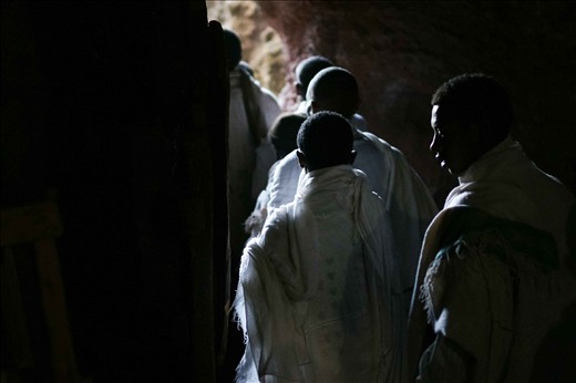  Narrow tunnels underneath the churches and within the mountain connect the churches, and as the number of pilgrims swell dramatically with Christmas approaching, the passages become an increasingly tight traverse. Stories of long treks echo off the cool stone, with one pilgrim telling me of his group's barefoot journey of more than 8 days in order to reach Lalibela. As so many villages are within reach, more than 60,000 pilgrims descend on the churches each Christmas.