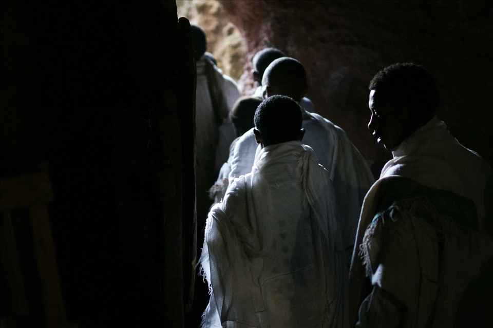  Narrow tunnels underneath the churches and within the mountain connect the churches, and as the number of pilgrims swell dramatically with Christmas approaching, the passages become an increasingly tight traverse. Stories of long treks echo off the cool stone, with one pilgrim telling me of his group's barefoot journey of more than 8 days in order to reach Lalibela. As so many villages are within reach, more than 60,000 pilgrims descend on the churches each Christmas.