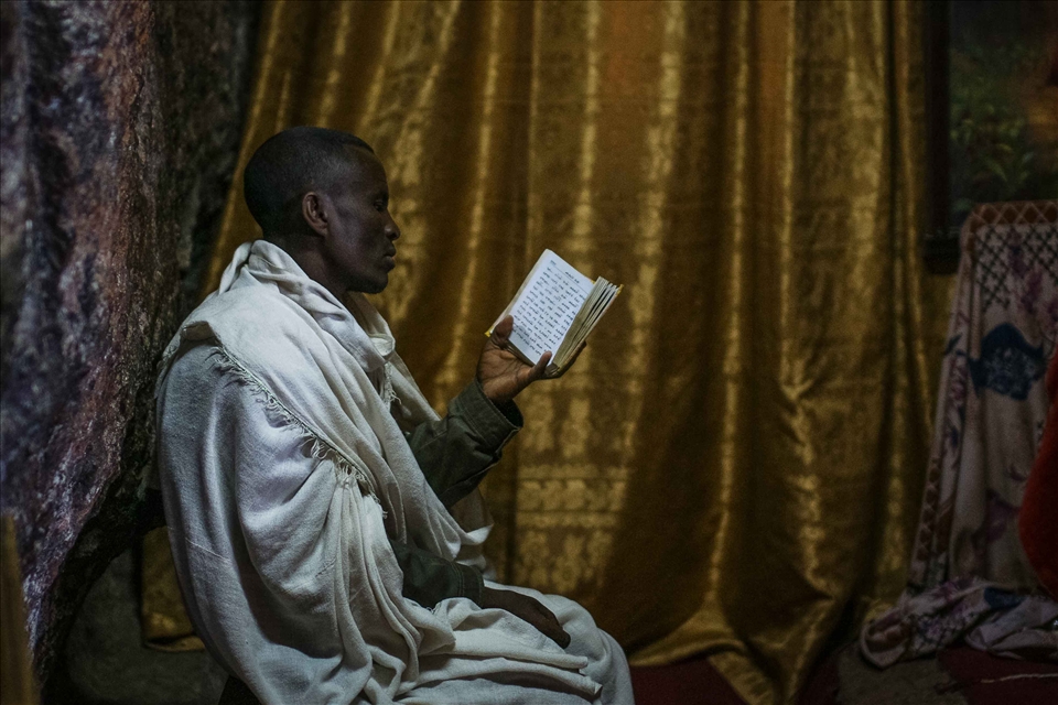 Resting against the rock face of the church, an Orthodox Christian is caught in a moment of contemplation. Each of the underground  churches contain a thick and richly coloured curtain hiding a replica of the Ark of the Covenant, viewable only by priests, deacons and bishops.
