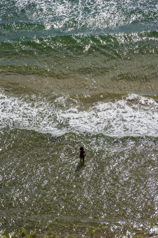 Challenging the waves. Gaeta. A woman is fighting the heat of the beginning of September taking a bath in the Mediterranean Sea. Gaeta is one of the few spots in Latium where it is still possible to find clear water.