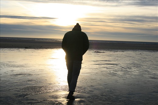 Icy denmark at the end of the day. A lonly figure struggling against the wind