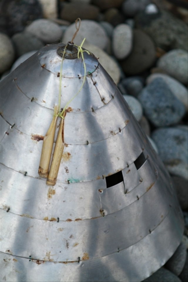 Before fishing for flying fish can begin, each village will have a traditional ceremony (招魚祭) to ensure good and safe fishing. The elder of the families will wear this helmet（銀盔） made from recycled tin cans or in some case silver coins to frighten away the evil ghosts that may endanger the fishermen or scare the flying fish away.